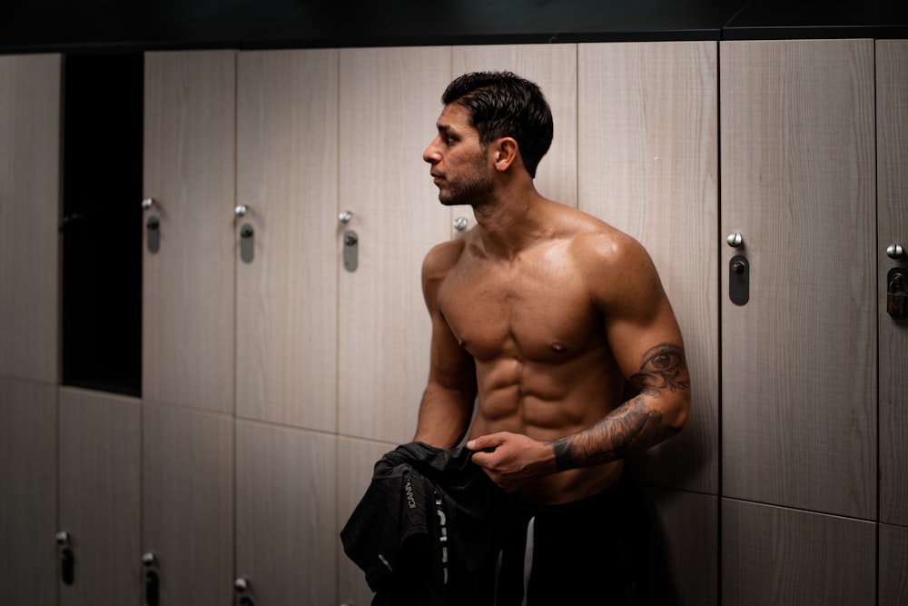 man leaning on gray locker