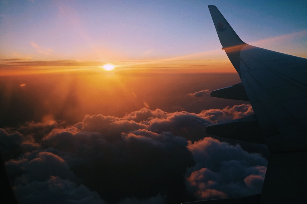 airplane over clouds during golden hour