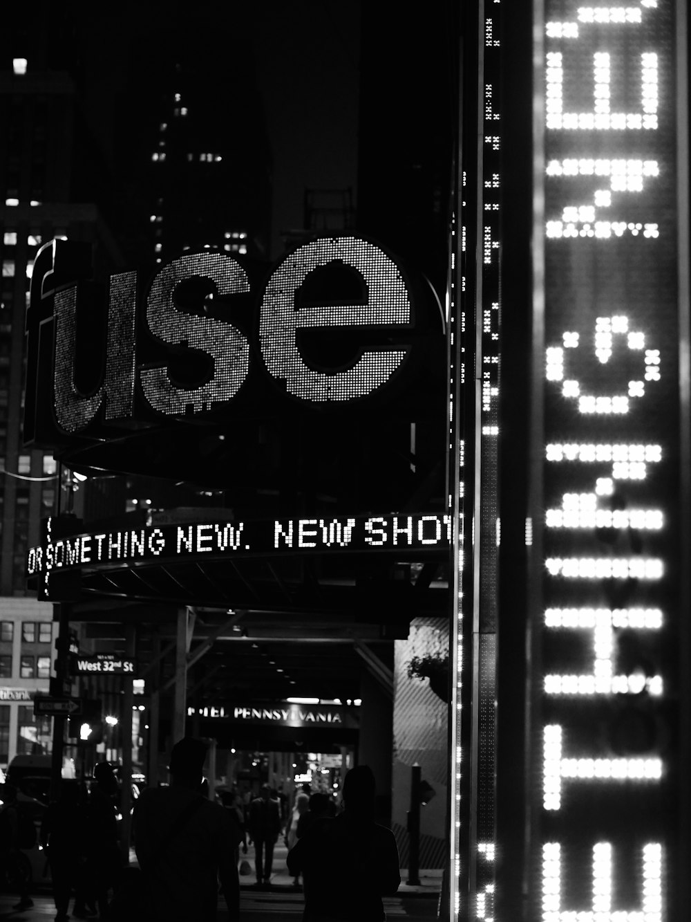 a black and white photo of a street sign