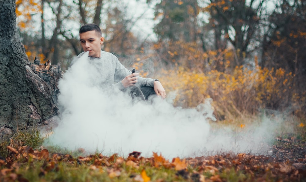 man smoking near tree at daytime