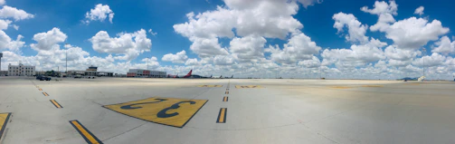 Wide-angle shot of a commercial airport runway with visible rejuvenation markings.