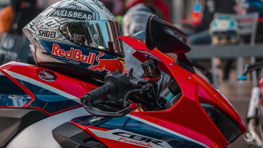 gray full-face helmet on red motorcycle