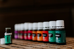 Close-up of essential oils bottles arranged neatly with fresh herbs