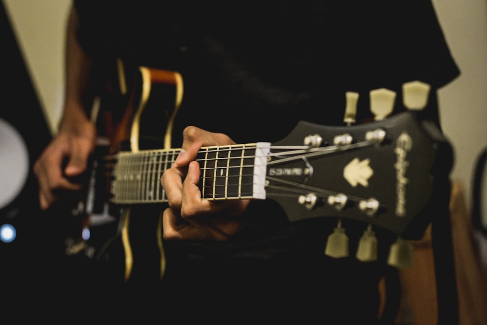 person playing electric guitar