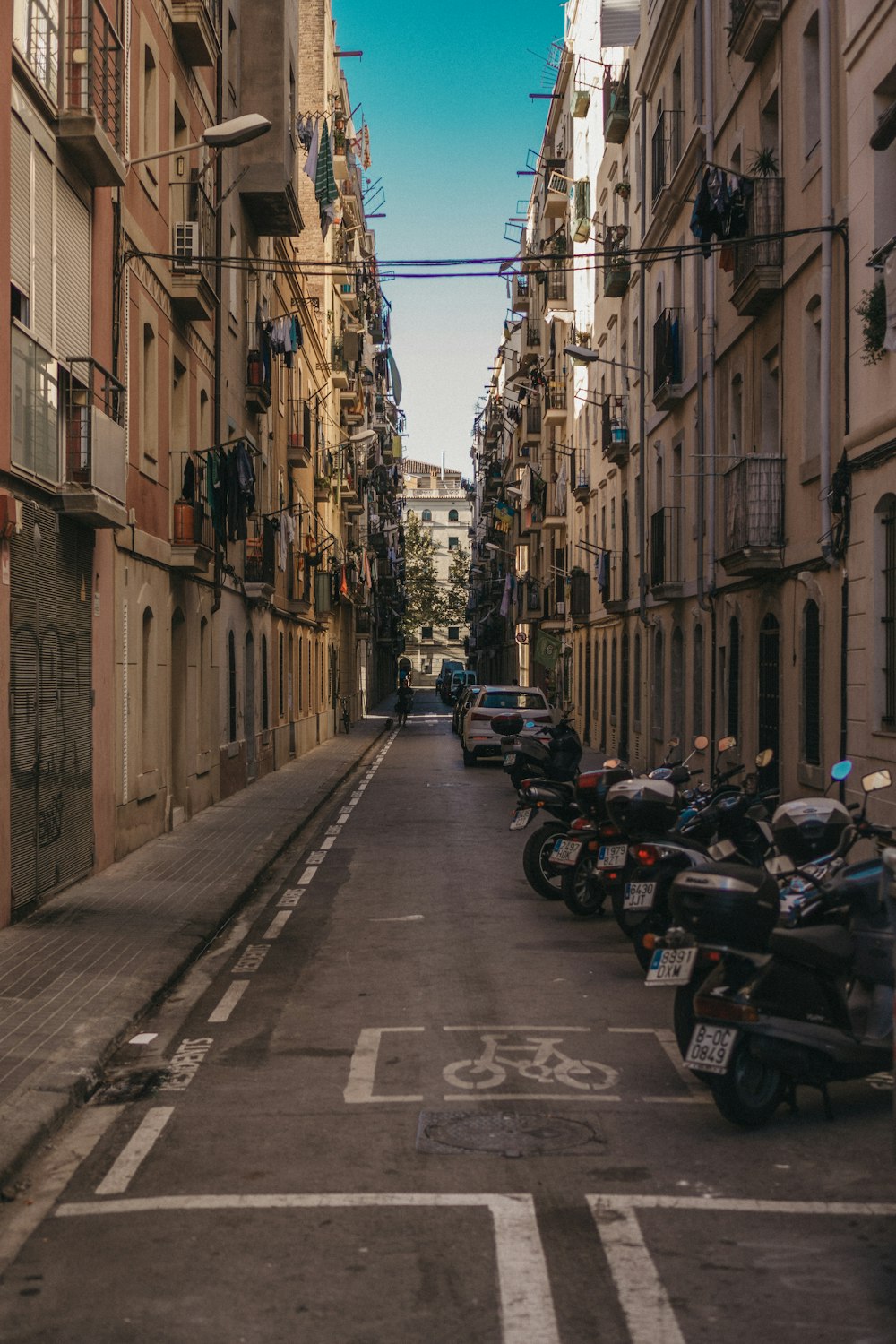 motorcycles park on pathway beside building during daytime