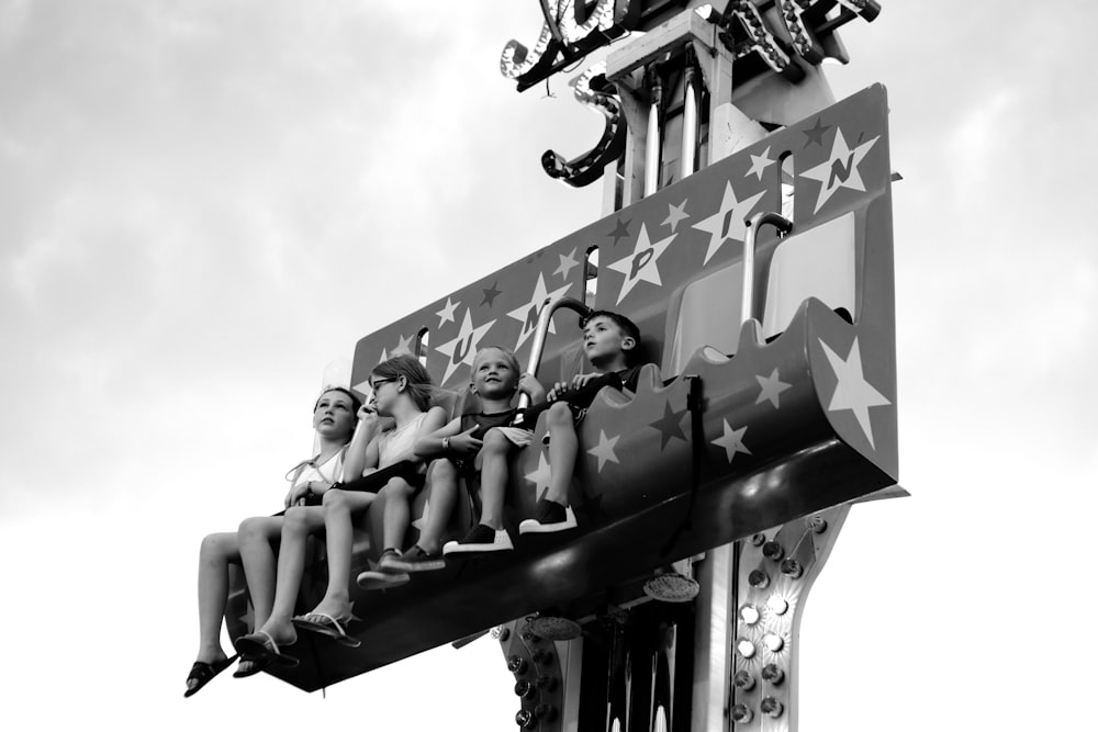 four children on carnival ride