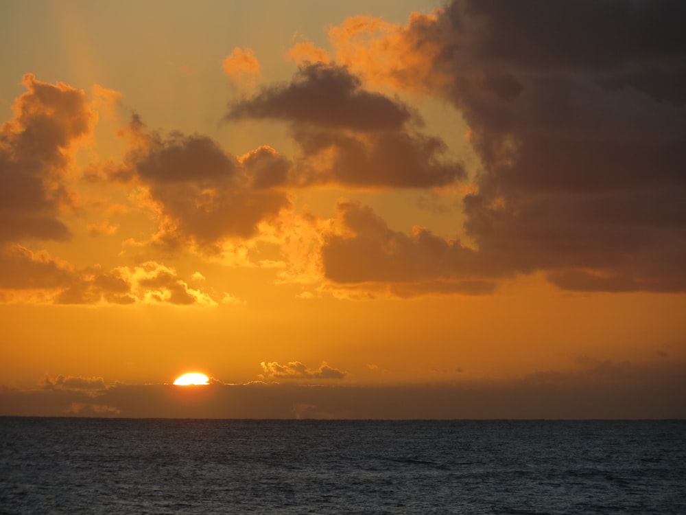 orange cloudy sunset sky over the sea