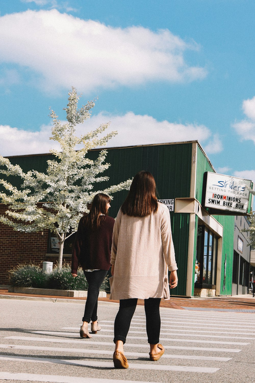 two women walking on pedestrian lane