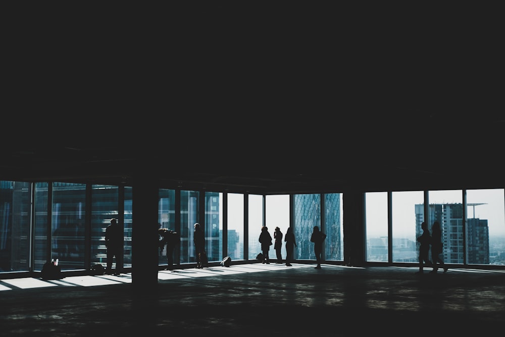 people walking near glass window inside building