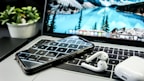 A close-up of a laptop with accessories on a desk.