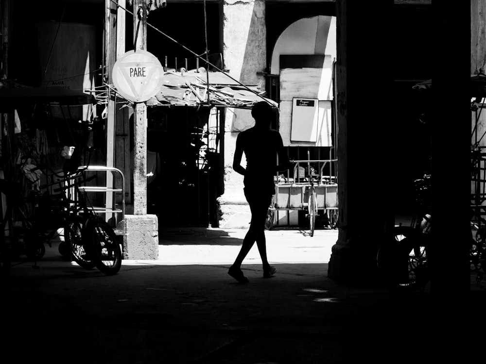 silhouette of person walking on street