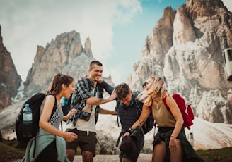 low-angle photography of two men playing beside two women