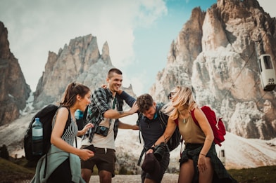 low-angle photography of two men playing beside two women