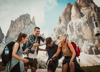 low-angle photography of two men playing beside two women