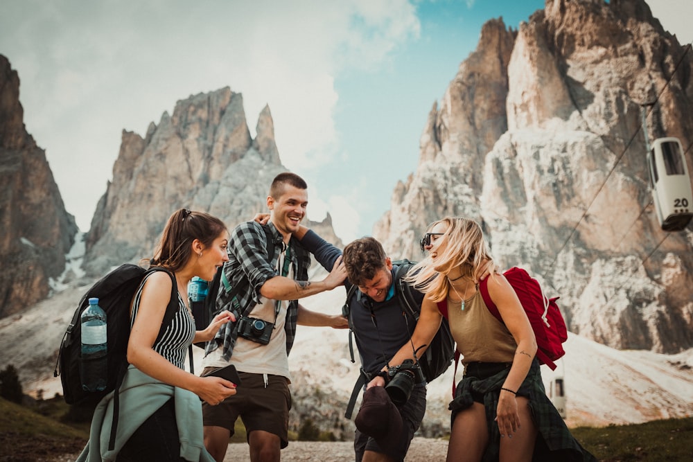 low-angle photography of two men playing beside two women