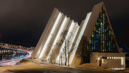 lighted architectural building during night time in Arctic Cathedral Norway