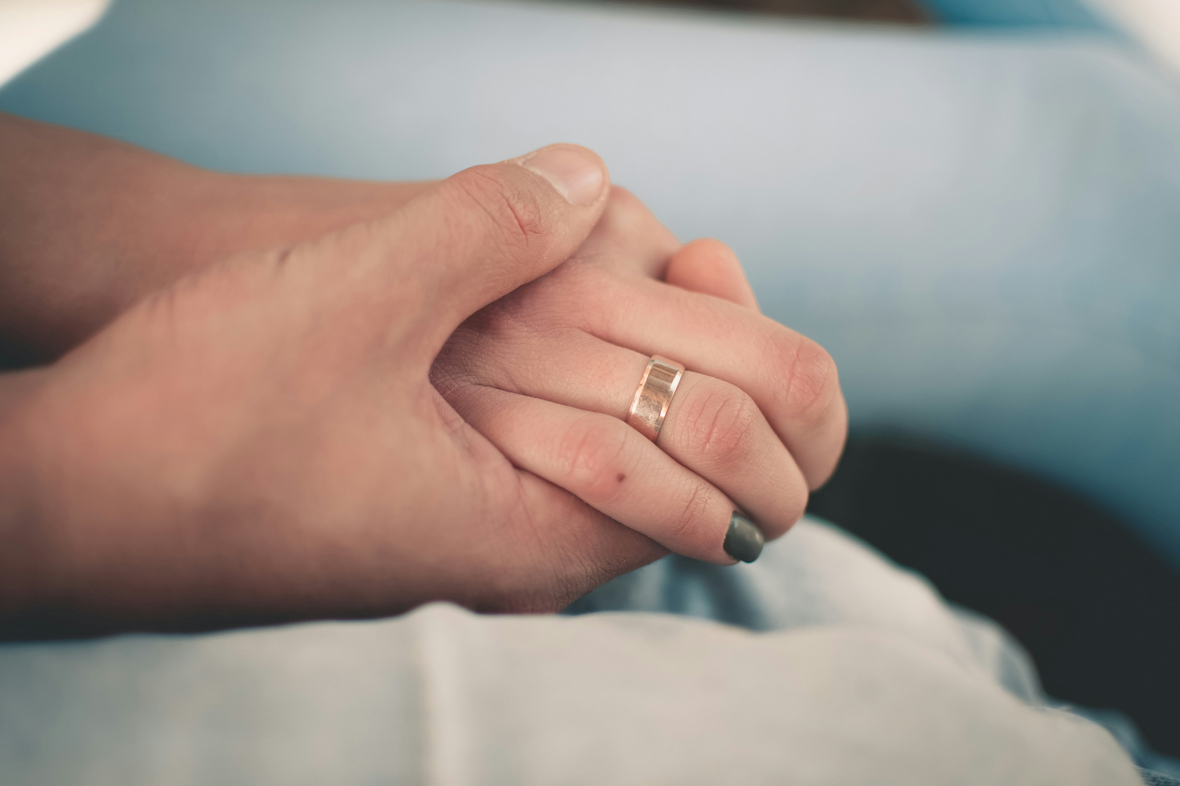 two persons holding their hands