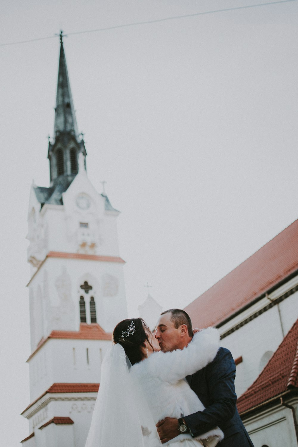 bridge and groom standing in front of cathedral