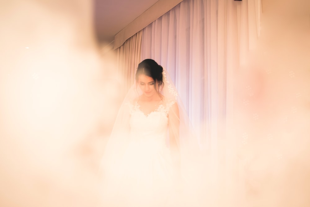 selective focus photography of woman in wedding dress