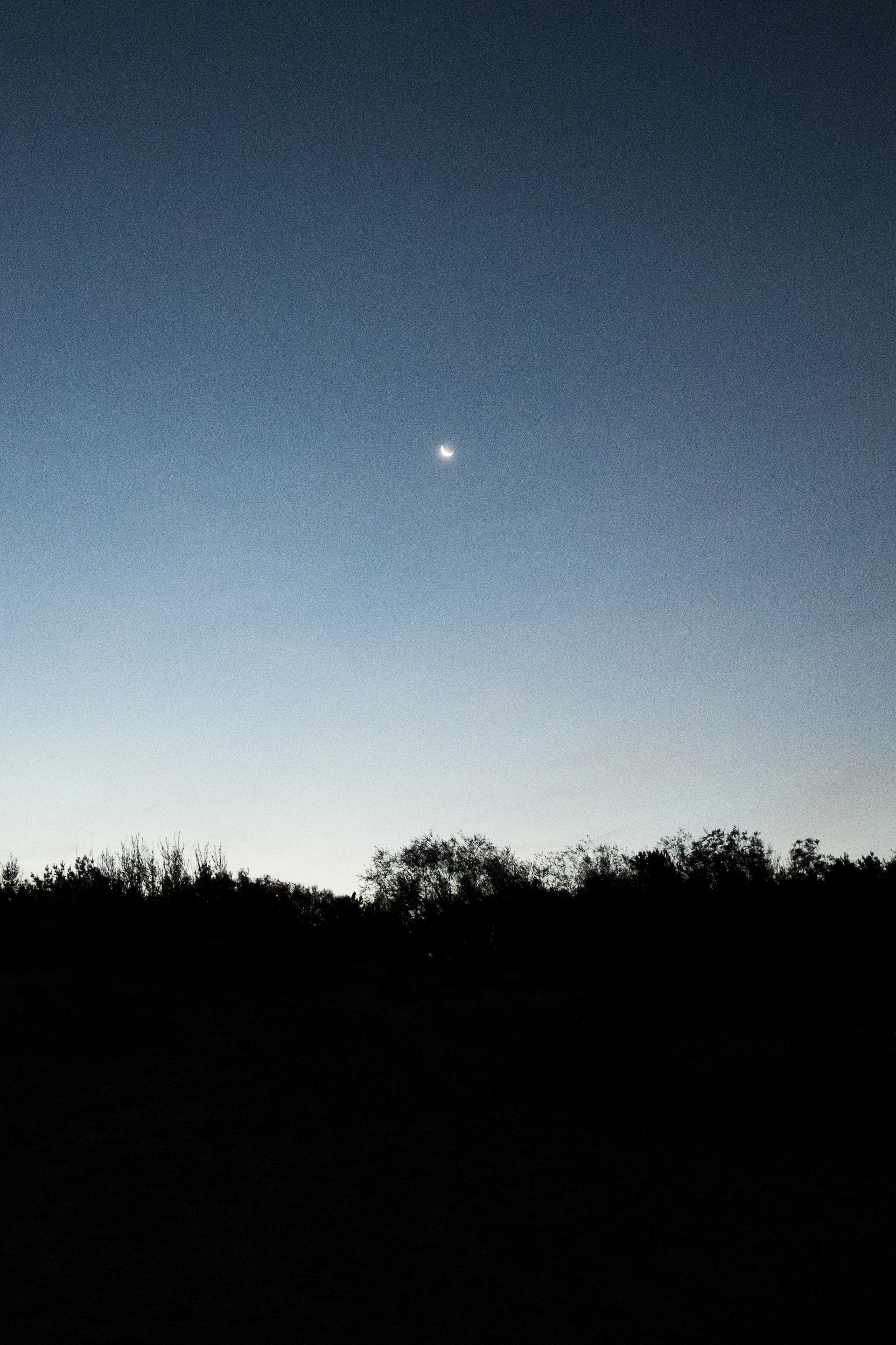 A serene twilight sky with a glowing crescent moon and sparkling stars, evoking a sense of spiritual awakening.