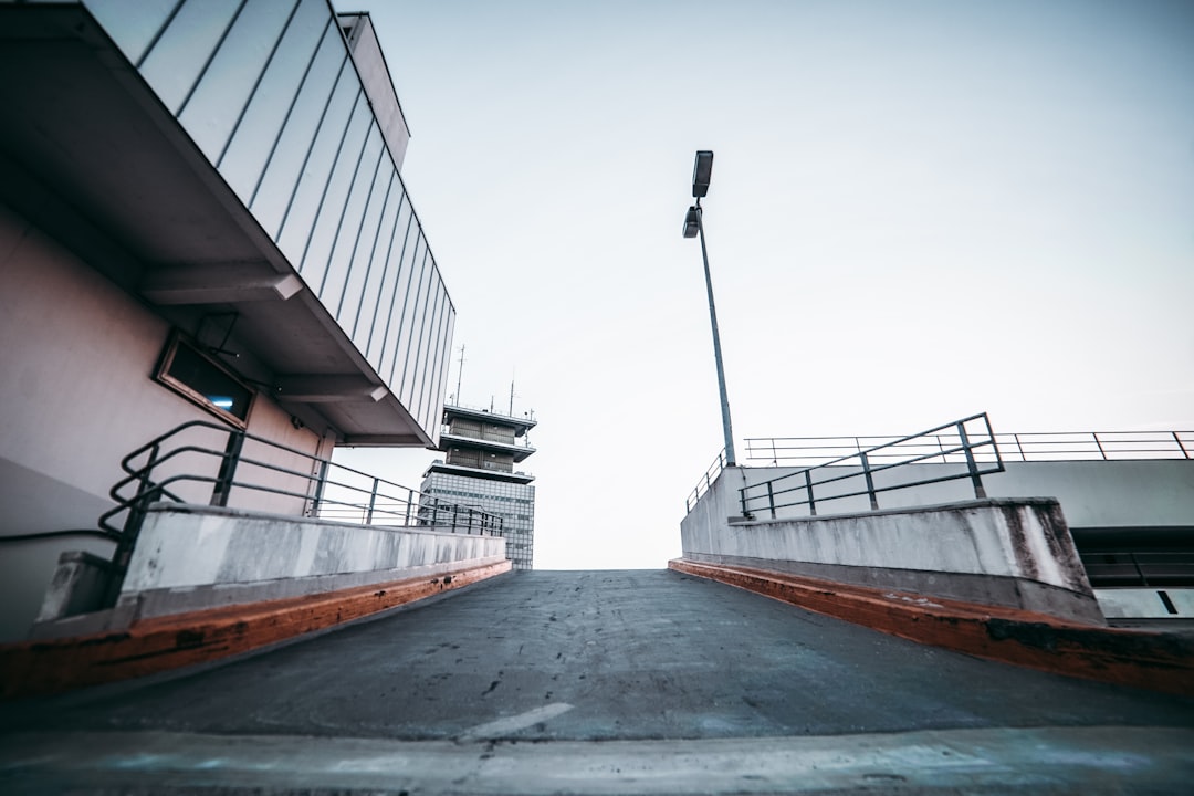 asphalt road between building under gray sky