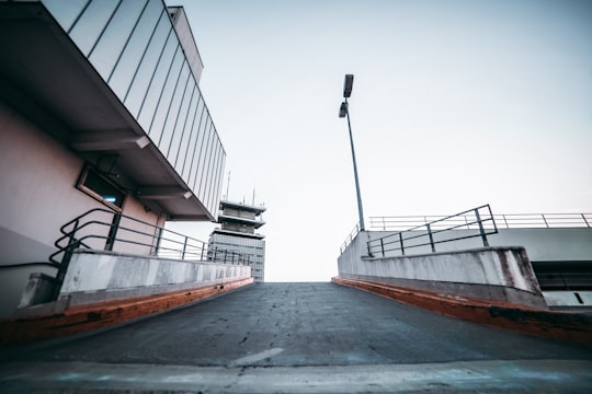 asphalt road between building under gray sky in Cologne Germany