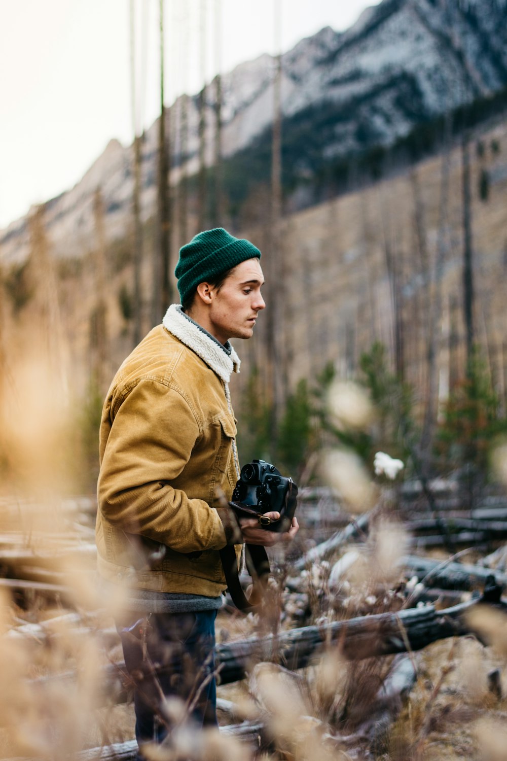 shallow focus photography of man holding camera
