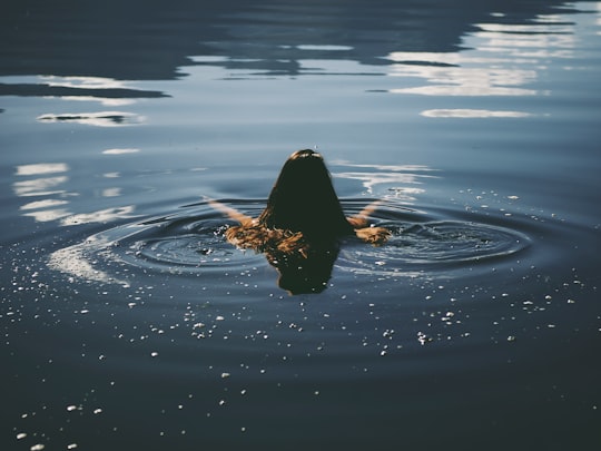 woman swim in water in Lago Rivadavia Argentina