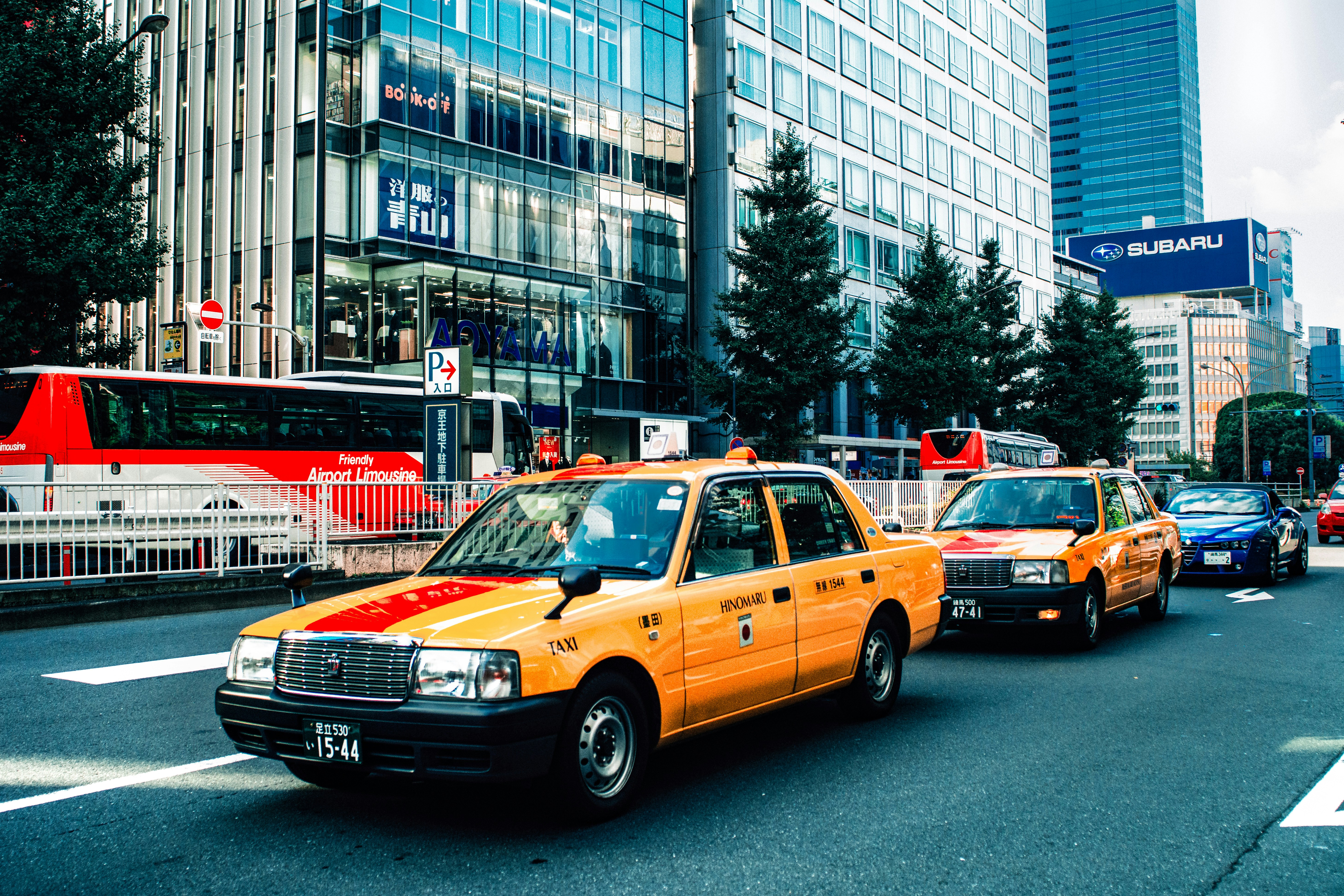 yellow sedan on road in city