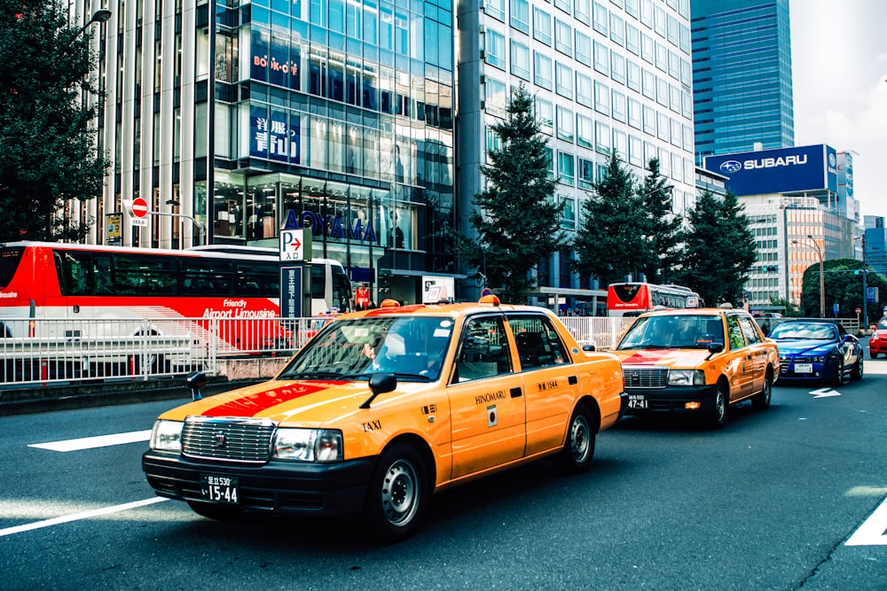 yellow sedan on road in city