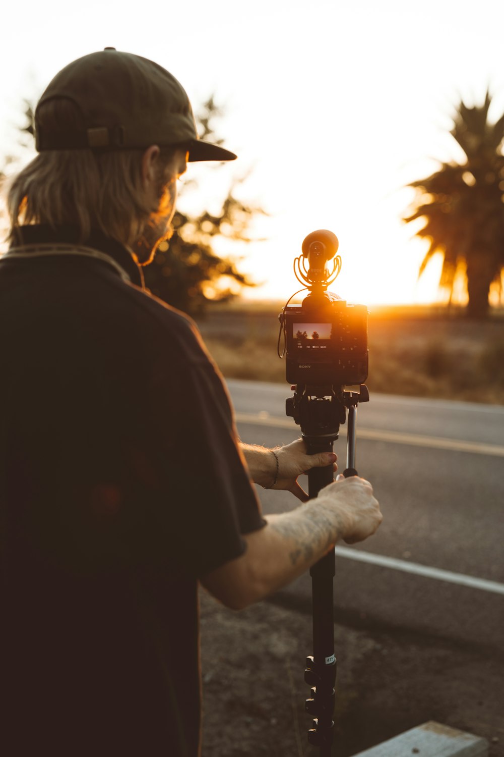 man standing near road and camera