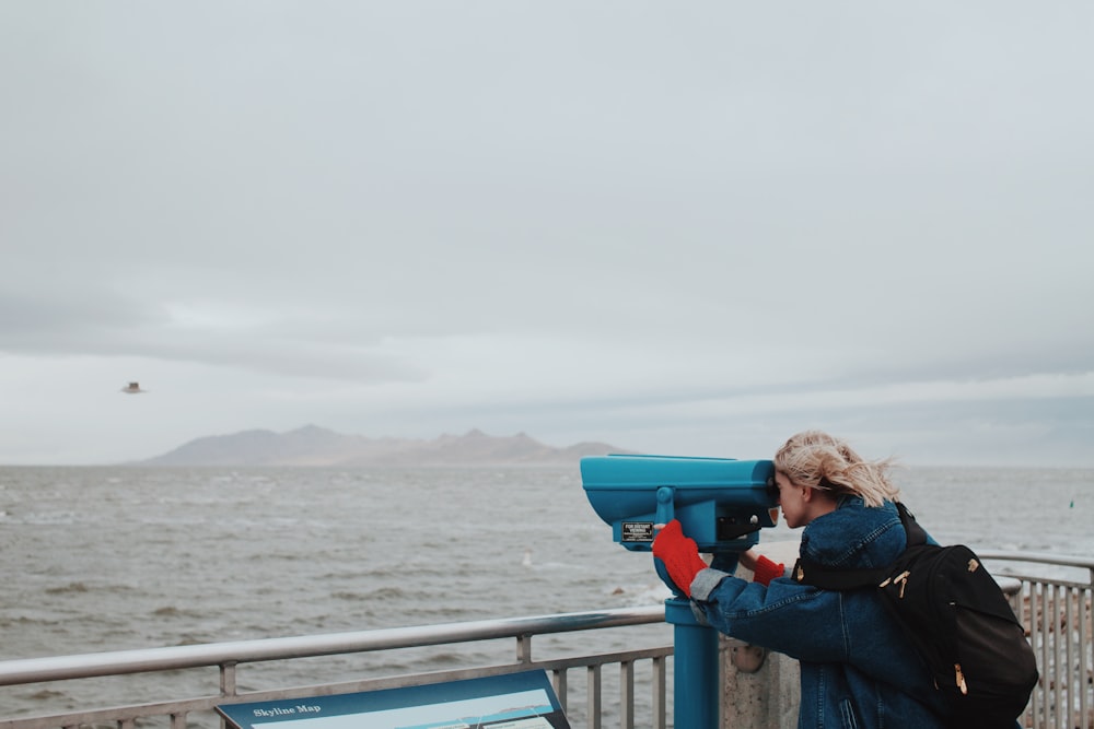 woman looking thru telescope