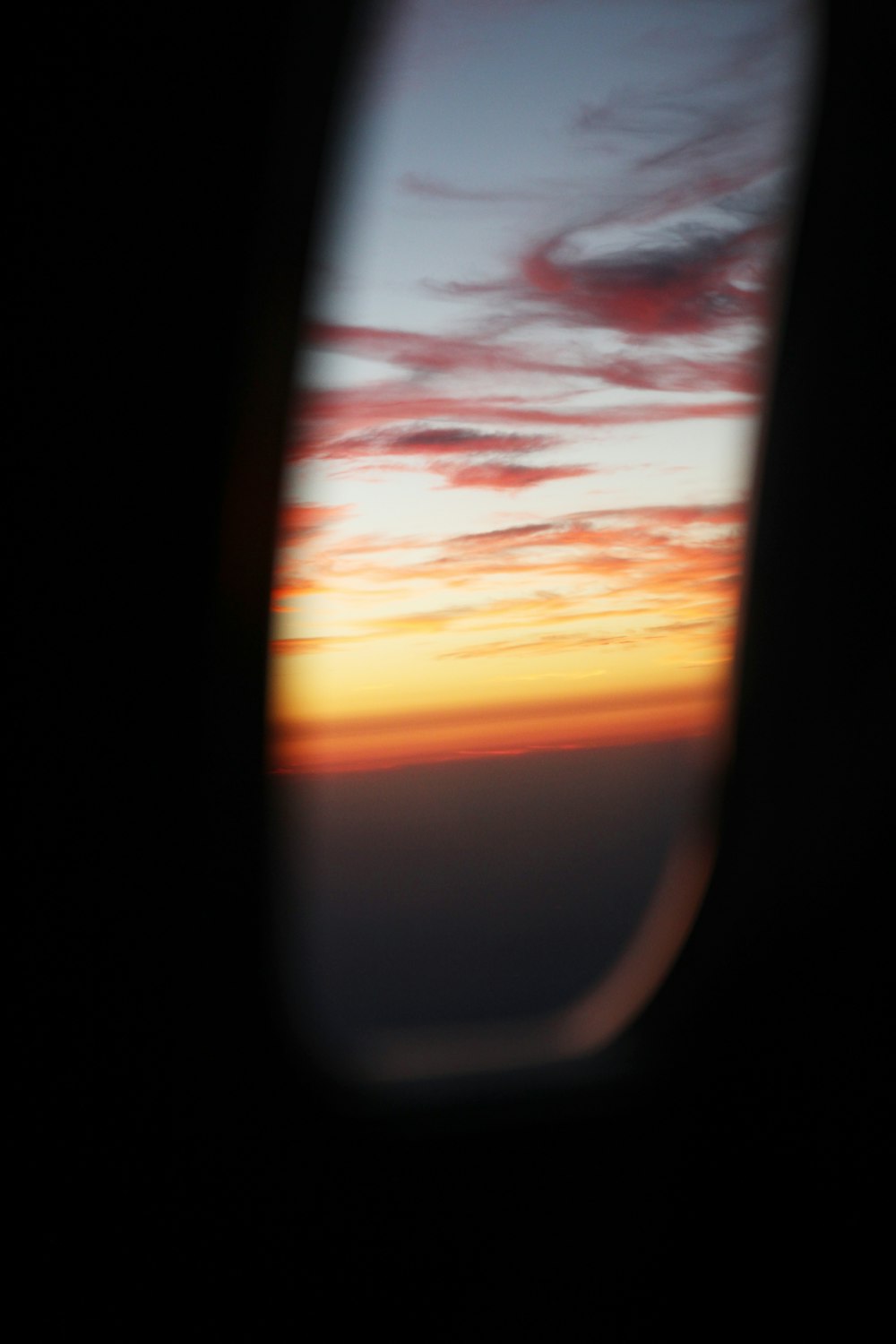 a view of a sunset from an airplane window