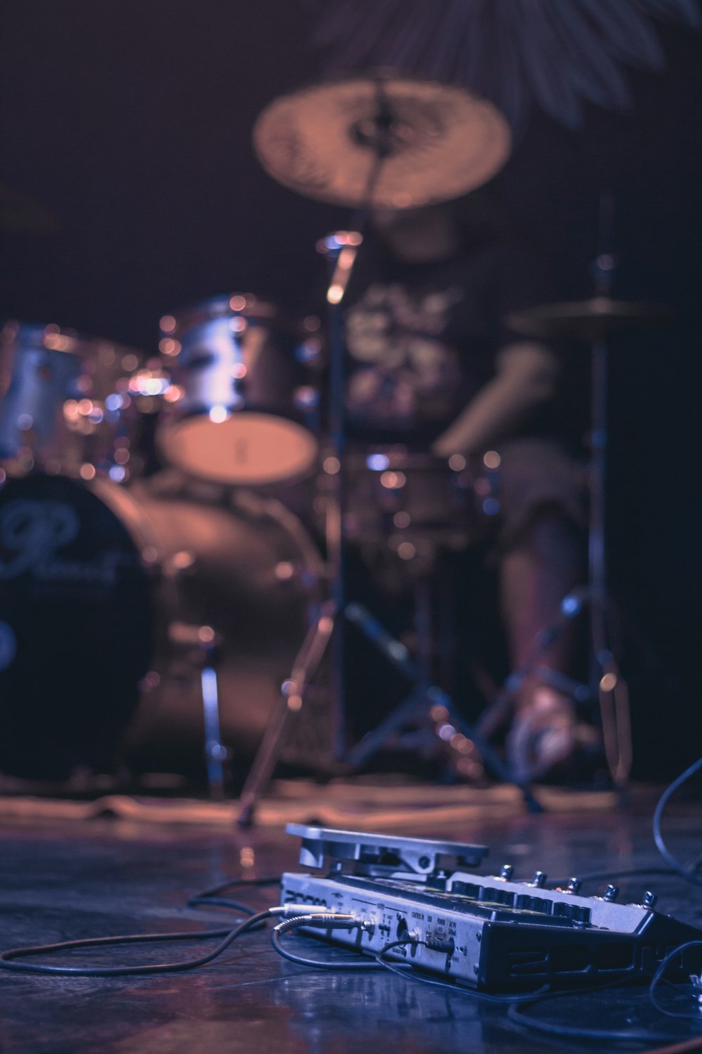 low-angle photography of man playing drum set