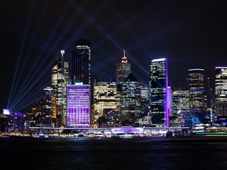 A vibrant night view of Nashville, Tennessee showcasing its illuminated buildings.
