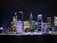 A vibrant night view of Nashville, Tennessee, showcasing illuminated buildings.