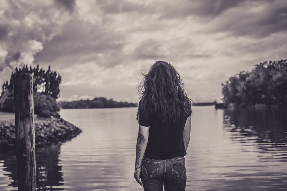 woman facing body of water