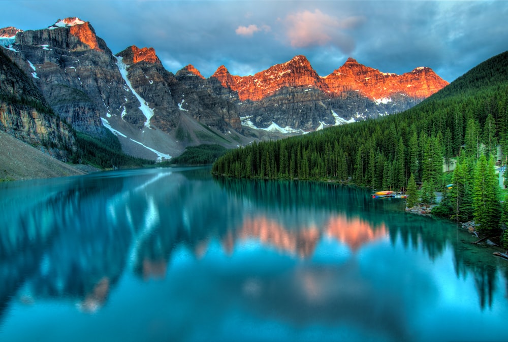 calm body of water and mountains wallpaper