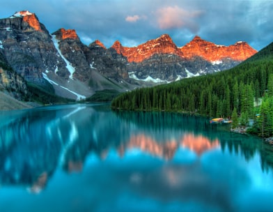 calm body of water and mountains wallpaper