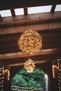 Rustic gazebo with hanging lanterns glowing warmly on a summer evening at the farm.