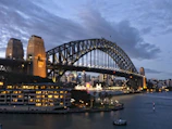 A panoramic view of a sleek steel bridge illuminated at dusk, symbolizing strength and precision.