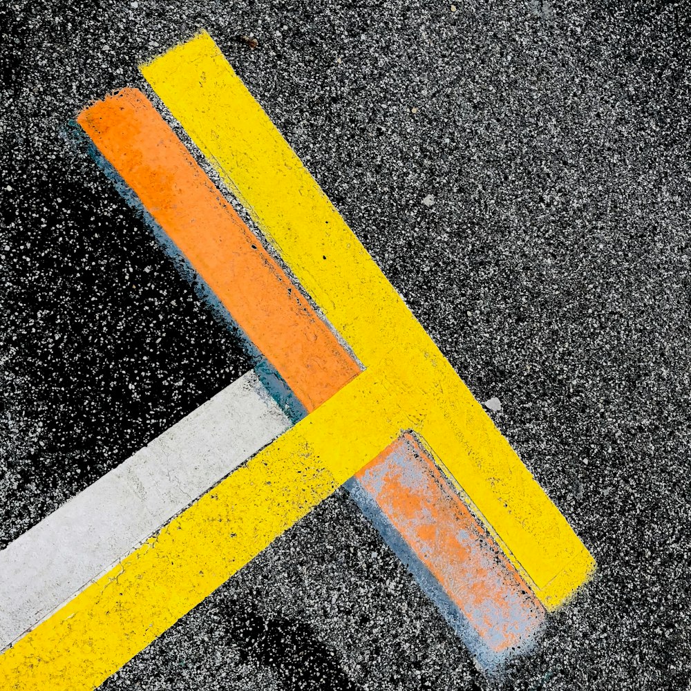 a close up of a street sign on the ground