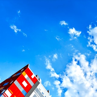 Close-up of a freshly painted modern building facade with vibrant colors under a clear sky