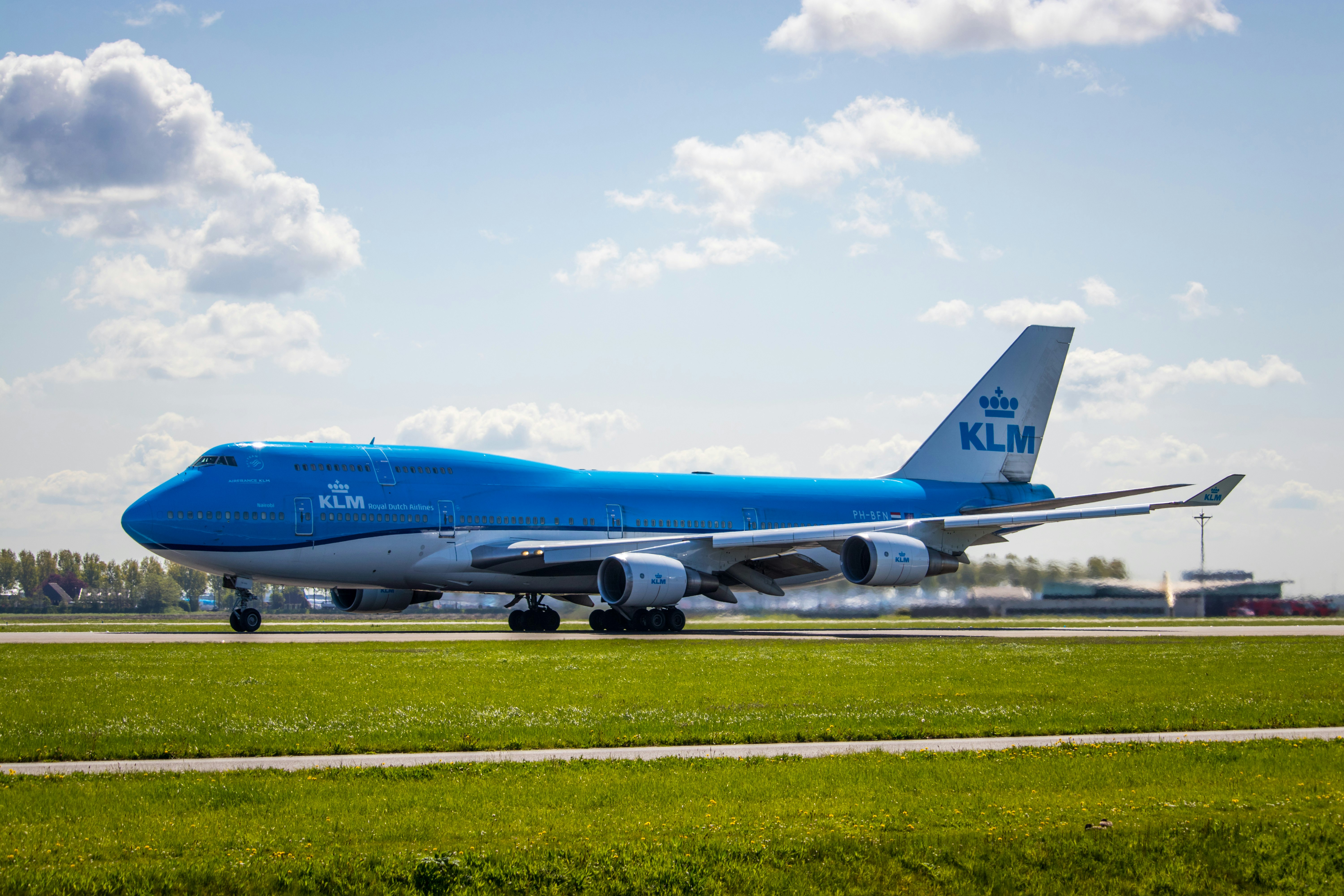 blue and white airplane on airport during daytime