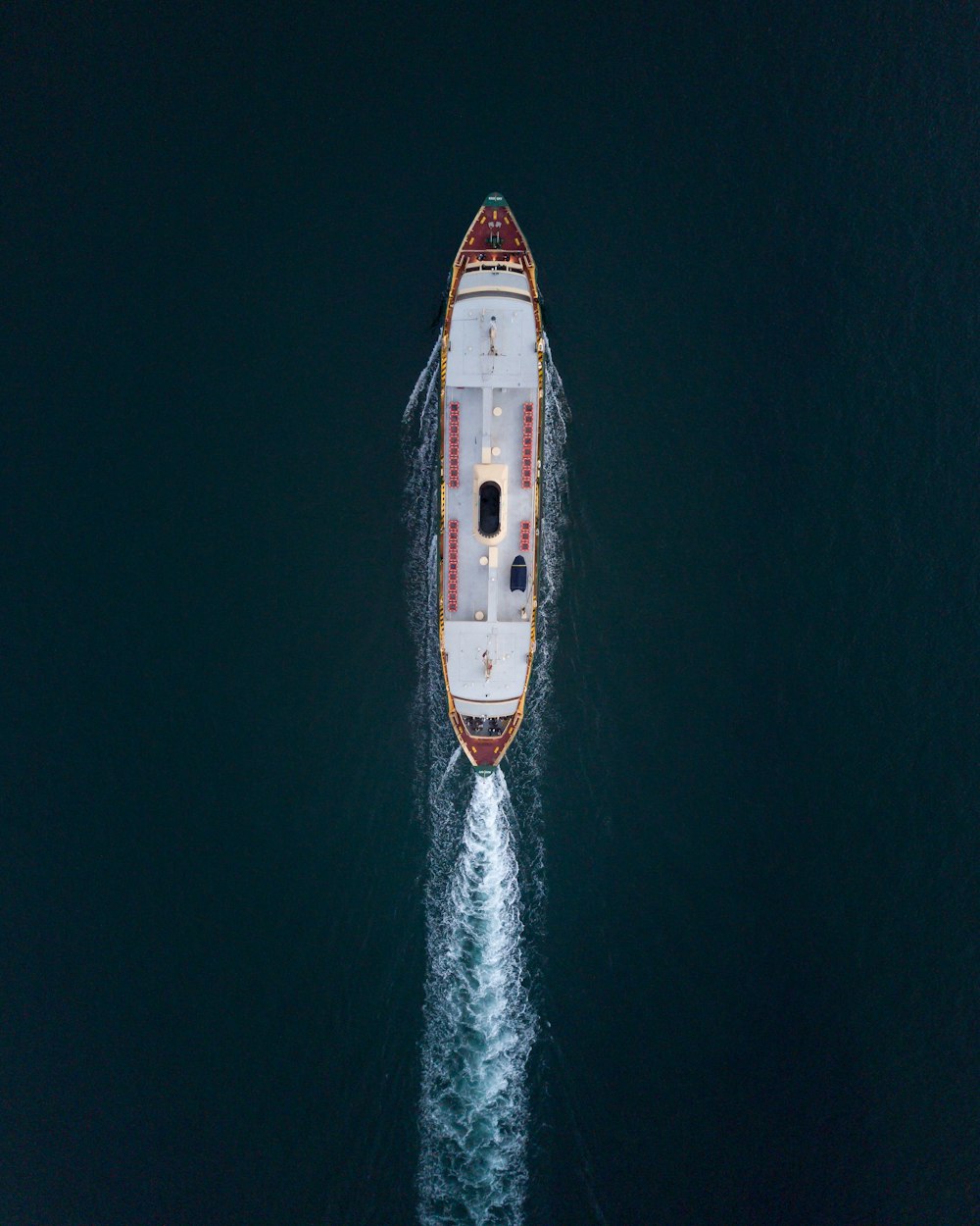 red and white ship on sea