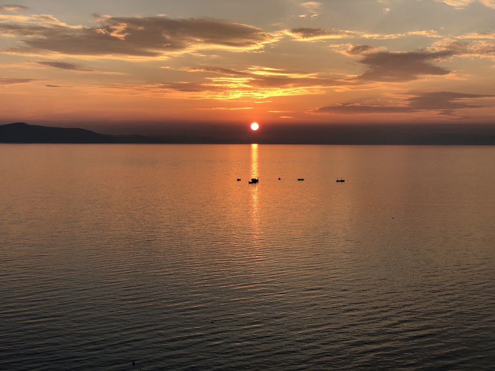 body of water with setting sun