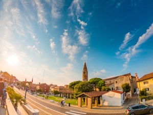 A peaceful view of Geneston village with people walking and interacting warmly in the town square.