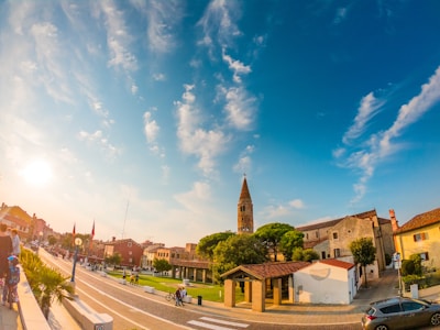 A peaceful view of Geneston village with people walking and interacting warmly in the town square.