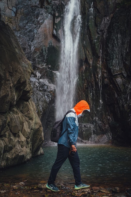man walking near waterfalls in Huzhou China