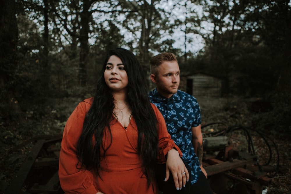 man standing near woman in forest